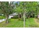 Beautiful home featuring a well-manicured lawn, mature trees, and lush landscaping offering shade and privacy at 642 Erin Way, Brooksville, FL 34601