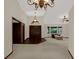 Grand foyer with double doors, chandelier, and natural light from large window at 642 Erin Way, Brooksville, FL 34601