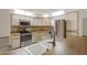 Well-lit kitchen offers stainless steel appliances, ample cabinetry, and modern finishes at 642 Erin Way, Brooksville, FL 34601