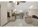 Open kitchen with white cabinetry, tile floors, stainless steel refrigerator, and modern appliances at 642 Erin Way, Brooksville, FL 34601
