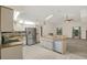 Bright kitchen features stainless steel appliances, white cabinetry, and a breakfast bar at 642 Erin Way, Brooksville, FL 34601
