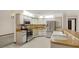 Updated kitchen features stainless steel appliances, white cabinetry, and modern fixtures at 642 Erin Way, Brooksville, FL 34601