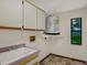 Laundry room with cabinets, utility sink and water heater at 642 Erin Way, Brooksville, FL 34601