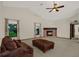 Living room featuring corner fireplace and large windows at 642 Erin Way, Brooksville, FL 34601