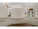 Open-concept living area features plush carpeting, a decorative chandelier, and natural light at 642 Erin Way, Brooksville, FL 34601