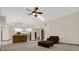 Spacious living room flows into the kitchen, featuring a fan and comfortable seating at 642 Erin Way, Brooksville, FL 34601