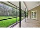 Screened patio with decorative stone flooring and view of green backyard at 642 Erin Way, Brooksville, FL 34601