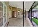 Covered patio with stone flooring, ceiling fan, and view to the back yard at 642 Erin Way, Brooksville, FL 34601