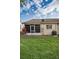 Backyard with a screened-in lanai and healthy grass at 6425 Thicket Trl, New Port Richey, FL 34653