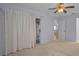 Bedroom showcasing plush carpet, a ceiling fan and an entrance to a private patio at 6425 Thicket Trl, New Port Richey, FL 34653