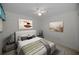 Comfortable bedroom featuring a ceiling fan, carpeted floor, and neutral wall color at 6425 Thicket Trl, New Port Richey, FL 34653