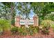 Attractive community entrance with brick signage and lush landscaping at 6425 Thicket Trl, New Port Richey, FL 34653
