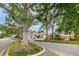 A welcoming community entrance with mature trees and attractive landscaping at 6425 Thicket Trl, New Port Richey, FL 34653