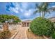 Community pool area features a gated pool, paved patio, seating and a covered lounge area with shade at 6425 Thicket Trl, New Port Richey, FL 34653
