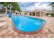 A sparkling community pool with a covered lounge area at 6425 Thicket Trl, New Port Richey, FL 34653