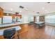 The community room features a kitchen, ample seating, plenty of light and a bookshelf with reading material at 6425 Thicket Trl, New Port Richey, FL 34653