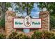 Welcoming Briar Patch community entrance sign with brick columns and manicured landscaping at 6425 Thicket Trl, New Port Richey, FL 34653