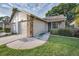 Charming home featuring a two-car garage, a well-manicured lawn, and clean, neutral siding at 6425 Thicket Trl, New Port Richey, FL 34653