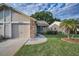 The attractive exterior features a well-kept lawn, neutral siding and a charming palm tree at 6425 Thicket Trl, New Port Richey, FL 34653