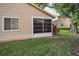 Exterior view of home with screened in patio, siding, and lush landscaping at 6425 Thicket Trl, New Port Richey, FL 34653