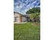 Inviting home exterior with lush green lawn and mature palm trees at 6425 Thicket Trl, New Port Richey, FL 34653