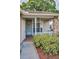 Close-up of the front porch, featuring a cozy entrance with well-maintained landscaping at 6425 Thicket Trl, New Port Richey, FL 34653