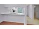 A bright kitchen featuring white cabinets and stainless steel sink at 6425 Thicket Trl, New Port Richey, FL 34653