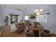 Living room and dining area combination with sliding door, ceiling fan, and chandelier at 6425 Thicket Trl, New Port Richey, FL 34653