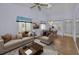 Cozy living room featuring neutral finishes, wood floors, and a dining nook at 6425 Thicket Trl, New Port Richey, FL 34653
