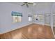 Open living room with hardwood floors, bright light, and a vaulted ceiling at 6425 Thicket Trl, New Port Richey, FL 34653