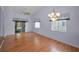 A view of the living area with a sliding glass door and a ceiling fan at 6425 Thicket Trl, New Port Richey, FL 34653