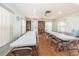 The recreation room boasts a serene environment with rows of tables and chairs, bathed in natural light, and complemented by a bookshelf at 6425 Thicket Trl, New Port Richey, FL 34653