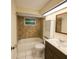 Cozy bathroom featuring a tub, shower, vanity, and neutral tile at 6450 Limerick Ave, New Port Richey, FL 34653