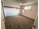 Spacious carpeted bedroom with window and open wall storage at 6450 Limerick Ave, New Port Richey, FL 34653