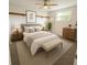 Cozy bedroom with plush carpeting, a comfortable bed, and bright natural light at 6450 Limerick Ave, New Port Richey, FL 34653