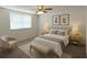 Bright bedroom with plush carpeting, a comfortable bed, and bright natural light at 6450 Limerick Ave, New Port Richey, FL 34653