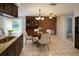 Dining room with wooden table, brick wall accent, and lots of natural light at 6450 Limerick Ave, New Port Richey, FL 34653