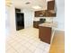 Well-lit kitchen features tile floors, stainless steel appliances, and granite countertops at 6450 Limerick Ave, New Port Richey, FL 34653