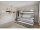 Bedroom showcasing a bunk bed with trundle, complemented by wall decor and neutral tones at 6490 Pine Meadows Dr, Spring Hill, FL 34606