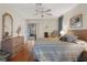 Comfortable bedroom with ceiling fan, laminate floors, and a relaxing atmosphere at 6490 Pine Meadows Dr, Spring Hill, FL 34606