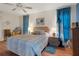 Comfortable bedroom with ceiling fan, laminate floors, and a relaxing atmosphere at 6490 Pine Meadows Dr, Spring Hill, FL 34606