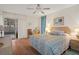Comfortable bedroom with ceiling fan, laminate floors, and a relaxing atmosphere at 6490 Pine Meadows Dr, Spring Hill, FL 34606
