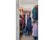 Walk-in closet with clothes, storage shelves, and personal items, providing ample storage space at 6490 Pine Meadows Dr, Spring Hill, FL 34606
