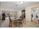 An interior view of a dining room with a glass table and cushioned chairs in a home at 6490 Pine Meadows Dr, Spring Hill, FL 34606