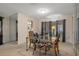 Comfortable dining area with large mirror and connection to kitchen at 6490 Pine Meadows Dr, Spring Hill, FL 34606
