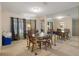 Dining room with glass table, chairs, carpet, and mirrored wall at 6490 Pine Meadows Dr, Spring Hill, FL 34606