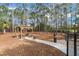 Community dog park featuring a wooden pergola with seating and lush green surroundings, perfect for pets and owners at 6490 Pine Meadows Dr, Spring Hill, FL 34606