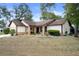 Charming one-story home featuring a well-maintained front yard and classic architectural details at 6490 Pine Meadows Dr, Spring Hill, FL 34606