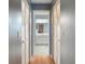 Hallway with closet doors, creating storage and leading to other areas at 6490 Pine Meadows Dr, Spring Hill, FL 34606