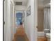 Hallway leading to a bathroom and living area, providing connectivity within the home at 6490 Pine Meadows Dr, Spring Hill, FL 34606